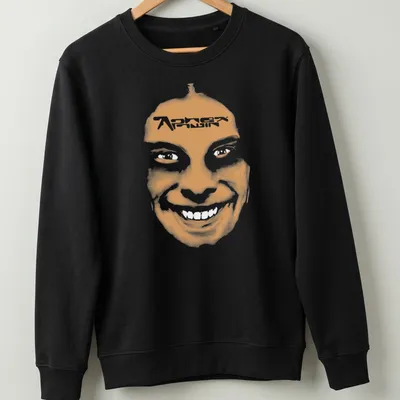 Minimalist t-shirt featuring a smiling face and 'Aphex Twin' text in orange and white. — printed on a unisex sweatshirt