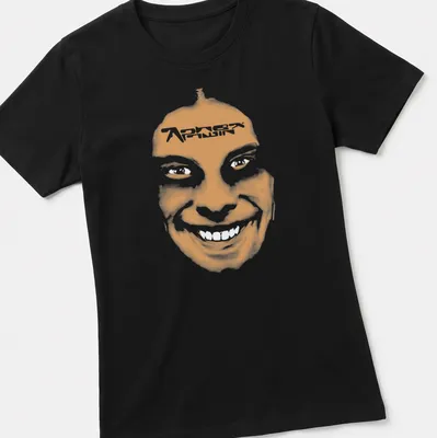 Minimalist t-shirt featuring a smiling face and 'Aphex Twin' text in orange and white. — printed on a women's shirt