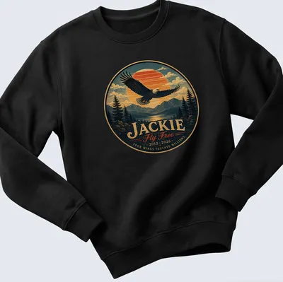 Vintage-style shirt featuring a bald eagle and memorial text in blue, orange, green, and brown. — printed on a unisex sweatshirt