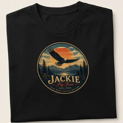 Vintage-style shirt featuring a bald eagle and memorial text in blue, orange, green, and brown.