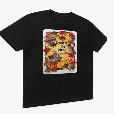 Collage of birds among autumn leaves with the text: Consider the birds Matthew 6:26 — printed on a unisex t-shirt (angled view)
