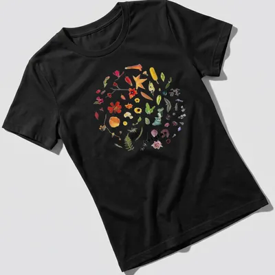 Botanical circle wreath design with colorful wildflowers and the word 'origins' — printed on a women's shirt