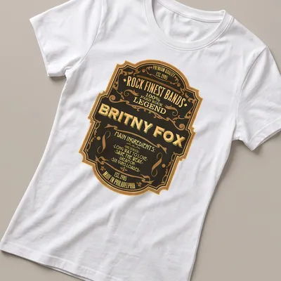 Vintage badge shirt featuring Britny Fox and their song titles in black, gold, and cream. — printed on a women's shirt