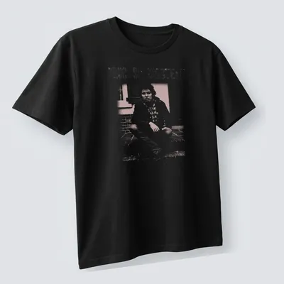 Fanart style t-shirt featuring Bruce Springsteen's name in white and light pink — printed on a unisex t-shirt (angled view)