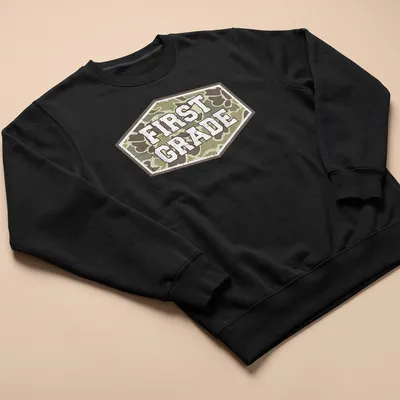 Vintage camo print t-shirt with 'FIRST GRADE' in bold lettering — printed on a unisex sweatshirt
