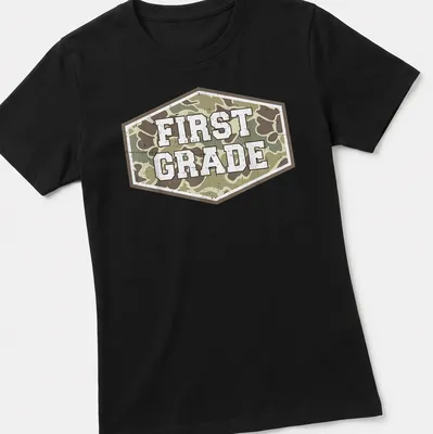 Vintage camo print t-shirt with 'FIRST GRADE' in bold lettering — printed on a women's shirt