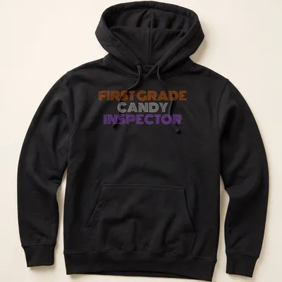 Bold striped Halloween tee featuring First Grade Candy Inspector text — printed on a unisex hoodie