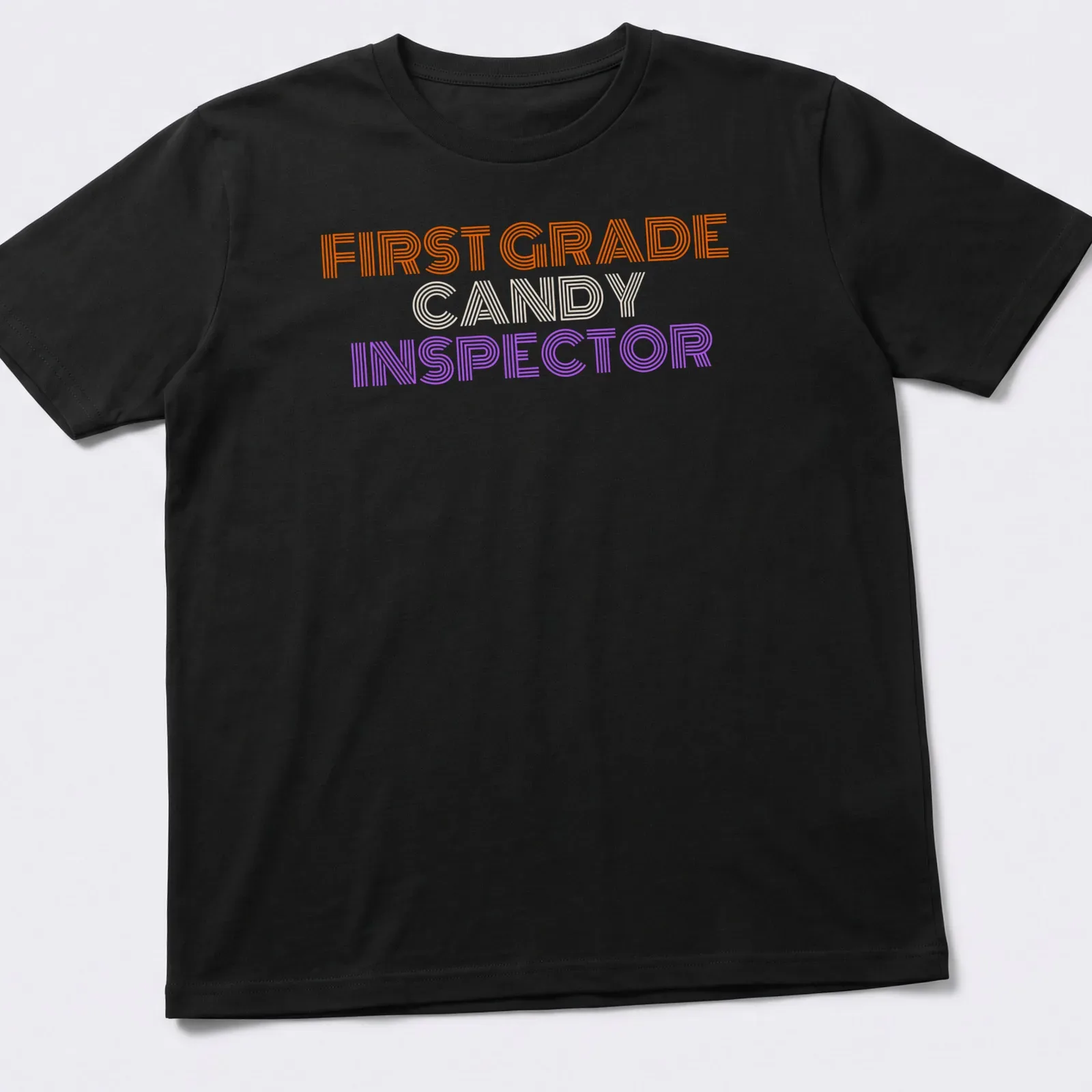 Bold striped Halloween tee featuring First Grade Candy Inspector text — printed on a unisex t-shirt