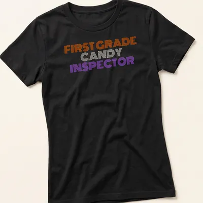 Bold striped Halloween tee featuring First Grade Candy Inspector text — printed on a women's shirt