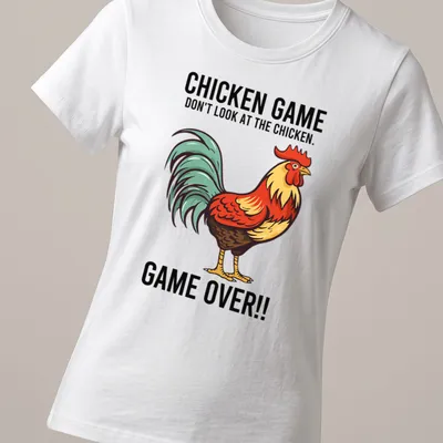 Vintage cartoon style Chicken Game t-shirt with colorful rooster and humorous text — printed on a women's shirt