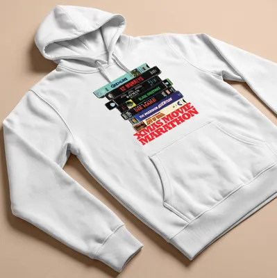 Vintage collage of Christmas movie VHS tapes with text 'XMAS MOVIE MARATHON' — printed on a unisex hoodie