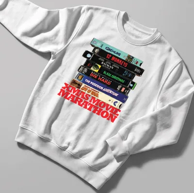 Vintage collage of Christmas movie VHS tapes with text 'XMAS MOVIE MARATHON' — printed on a unisex sweatshirt