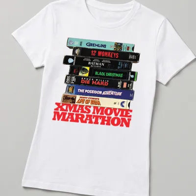Vintage collage of Christmas movie VHS tapes with text 'XMAS MOVIE MARATHON' — printed on a women's shirt
