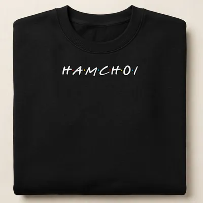 Playful typography shirt featuring colorful text 'HAM CHOI' in black, red, yellow, and blue. — printed on a unisex sweatshirt