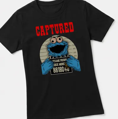 Cartoon mugshot of Cookie Monster with humorous text in blue, red, and black — printed on a women's shirt
