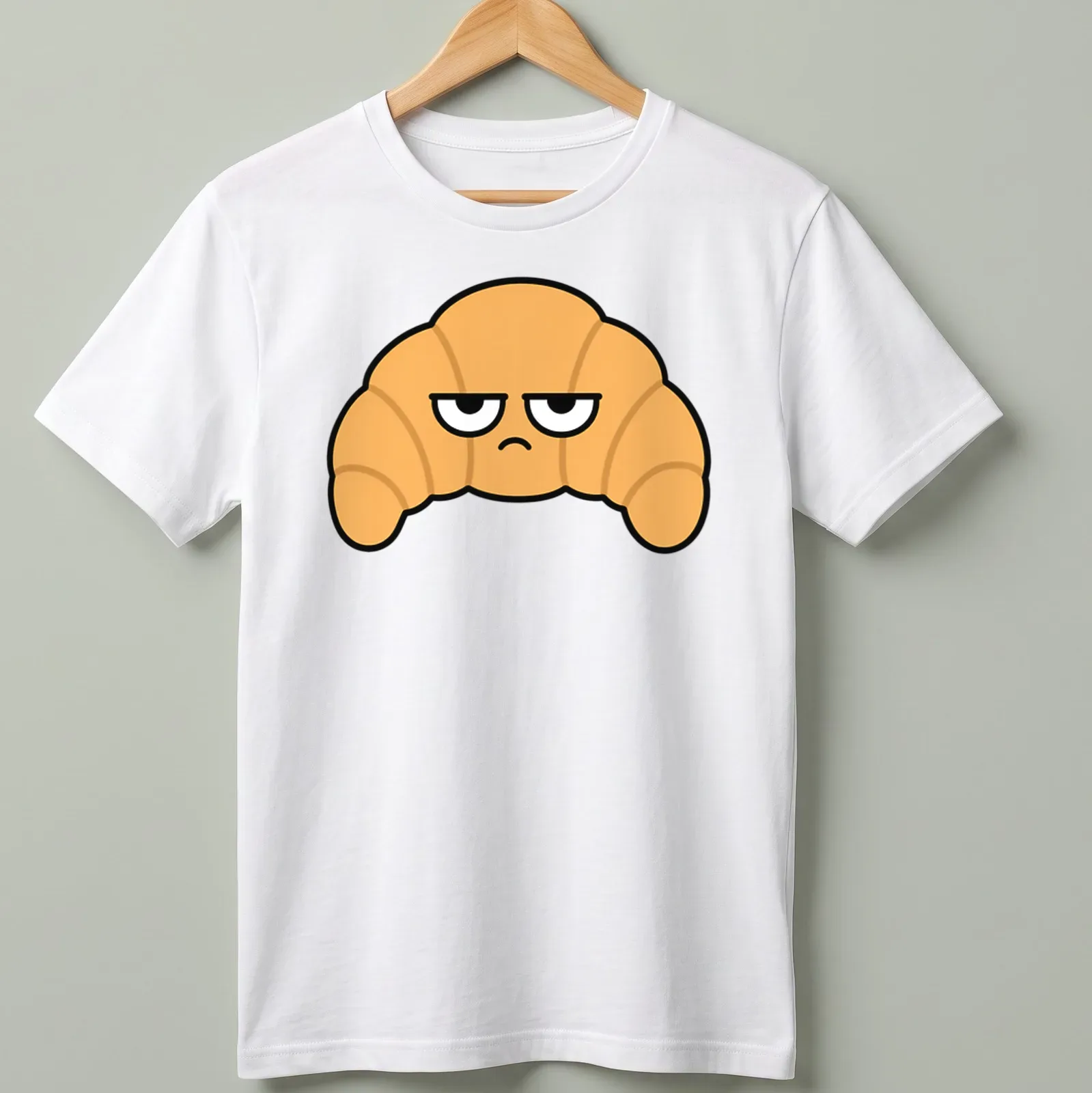 Cartoon croissant with the text 'Resting Bitch Face' in funny typography — printed on a unisex t-shirt