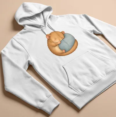 Kawaii illustration of a cute sleeping hamster on a blue pillow with soft colors — printed on a unisex hoodie