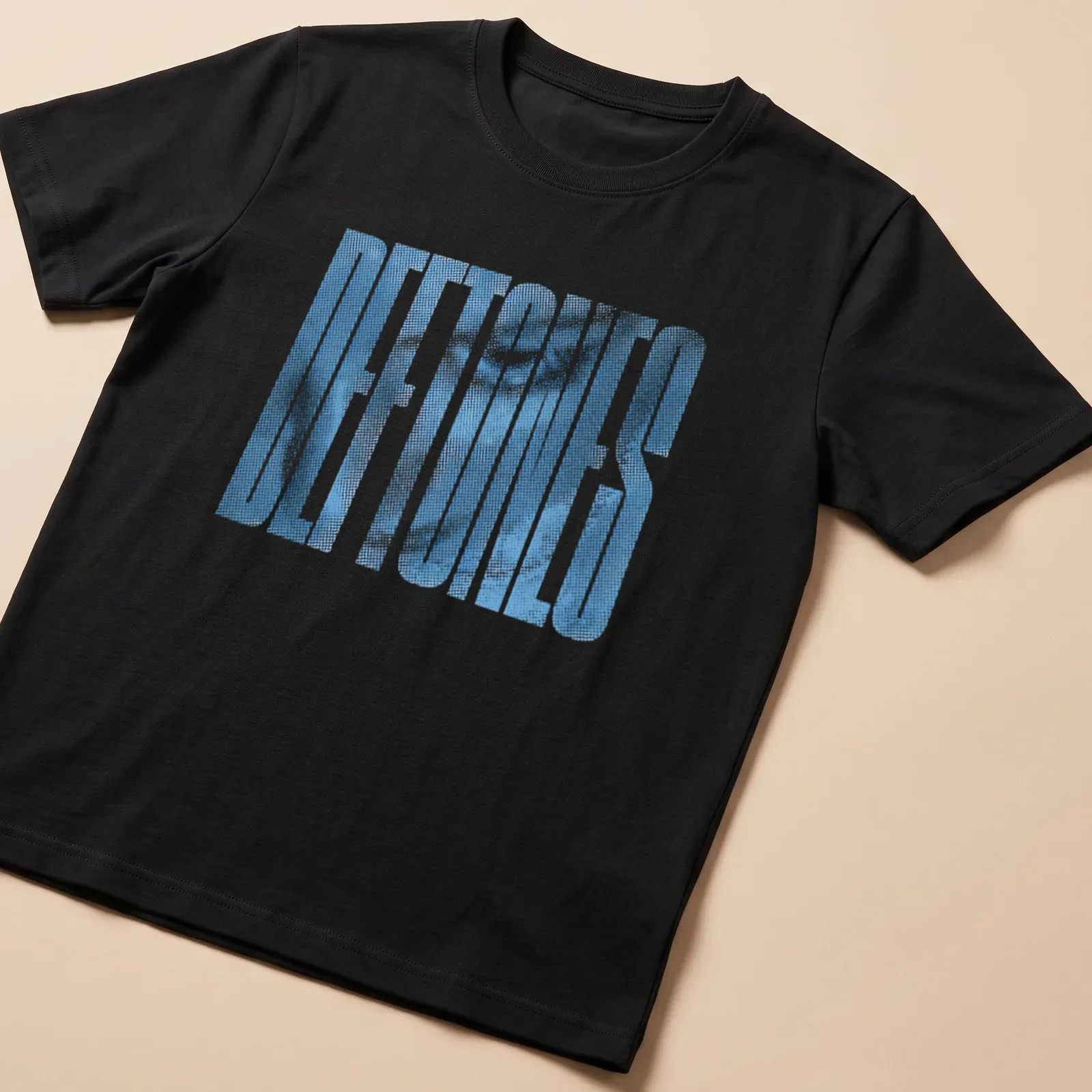 Halftone printed text 'DEFTONES' in blue on a retro style — printed on a unisex t-shirt