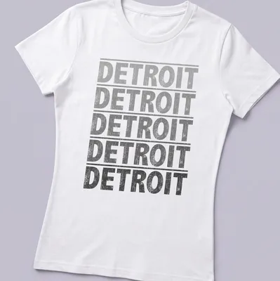 Distressed vintage Detroit t-shirt featuring bold slab lettering — printed on a women's shirt