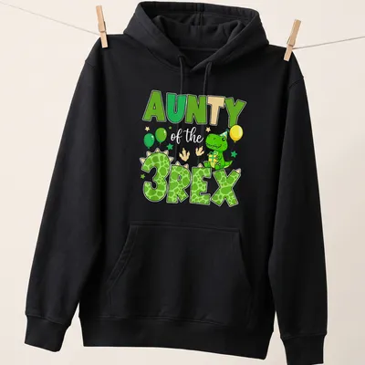 Cartoon dinosaur graphic with text 'AUNTY of the 3REX' for birthday celebrations. — printed on a unisex hoodie