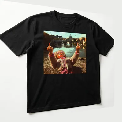 Distressed vintage t-shirt featuring a doll and meme text in pink, beige, and brown — printed on a unisex t-shirt (angled view)