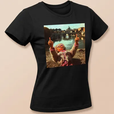 Distressed vintage t-shirt featuring a doll and meme text in pink, beige, and brown — printed on a women's shirt