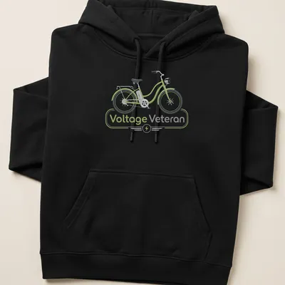 Modern illustrated E-bike graphic with text 'Voltage Veteran' in green and gray — printed on a unisex hoodie