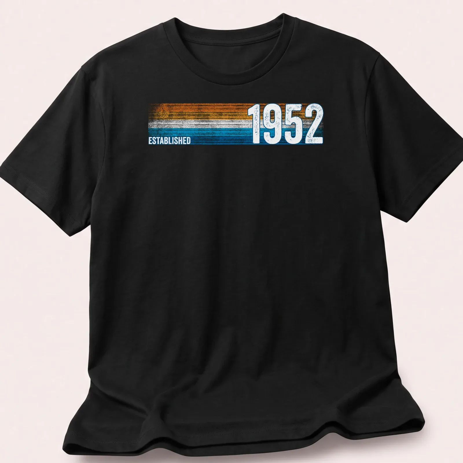 Vintage retro t-shirt with Established 1952 text in orange, blue, and white — printed on a unisex t-shirt