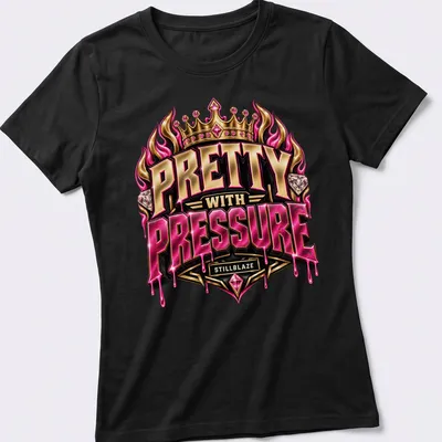 Illustration of a fiery crown with diamonds and text 'PRETTY WITH PRESSURE STILLBLAZE' — printed on a women's shirt