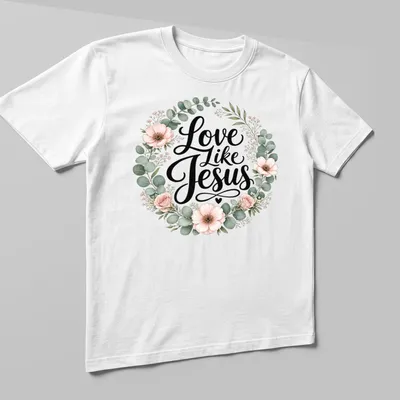 Floral wreath design with the text 'Love Like Jesus' in modern script — printed on a unisex t-shirt (angled view)