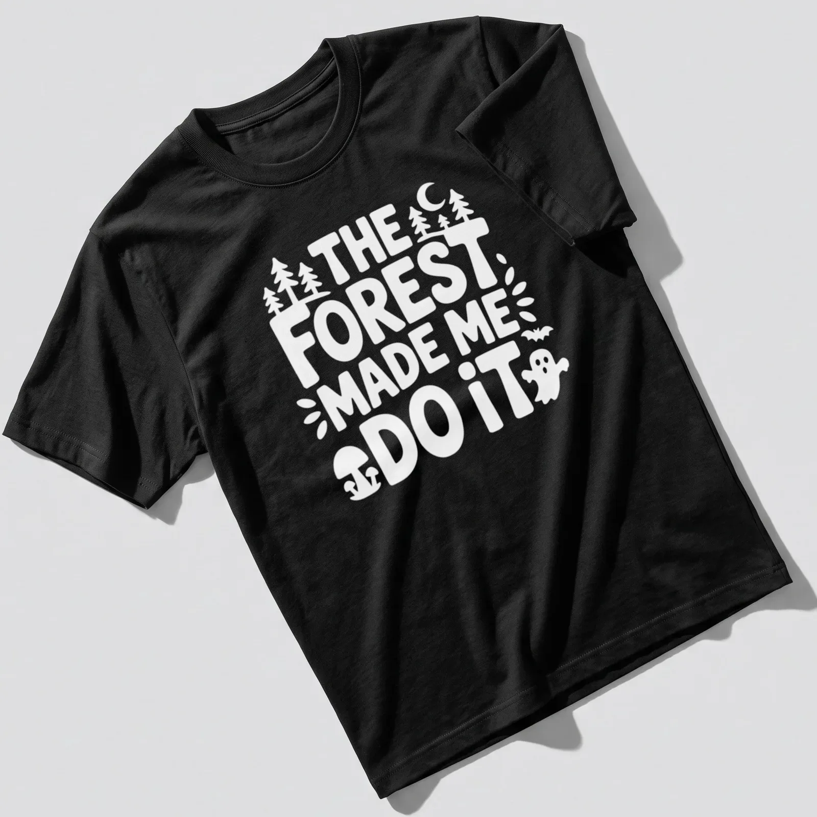Vintage print featuring a forest scene and the text The Forest Made Me Do It — printed on a unisex t-shirt
