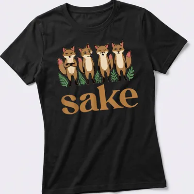 Cartoon design with four playful foxes and the text 'sake' in brown, cream, green, and pink. — printed on a women's shirt