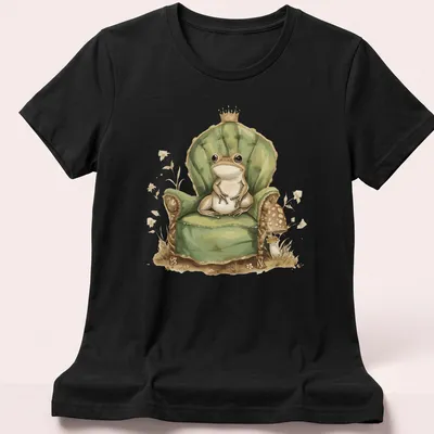 Whimsical illustration of a frog prince in a crown on his throne. — printed on a women's shirt
