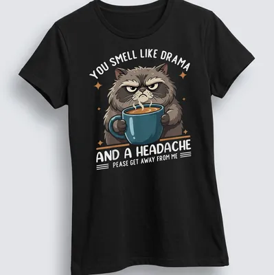 Cartoonish grumpy cat holding a coffee mug with humorous text about drama — printed on a women's shirt