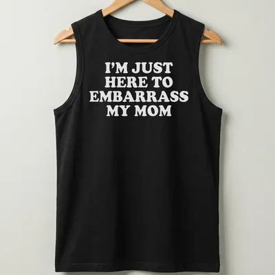 Bold white text humorously declares 'I'm Just Here To Embarrass My Mom' on a playful — printed on a tank top