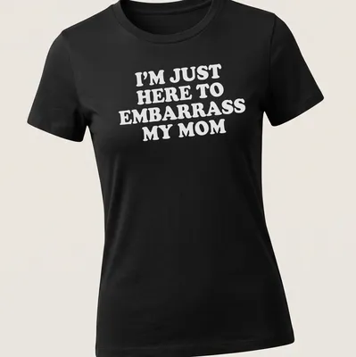 Bold white text humorously declares 'I'm Just Here To Embarrass My Mom' on a playful — printed on a women's shirt