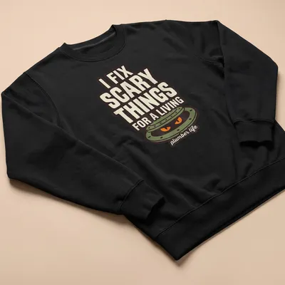 Illustration of a manhole cover with scary eyes and text I FIX SCARY THINGS FOR A LIVING. — printed on a unisex sweatshirt