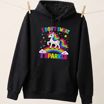 Colorful cartoon unicorn with the text 'I DON'T SWEAT I SPARKLE' in playful typography — printed on a unisex hoodie