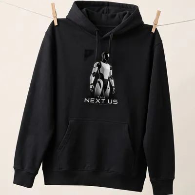 Silhouette of a futuristic humanoid robot with the text 'THE NEXT US' in black, white, and gray. — printed on a unisex hoodie