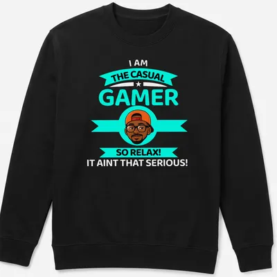 Cartoon design with text 'THE CASUAL GAMER SO RELAX!' in turquoise, black, orange, and white colors. — printed on a unisex sweatshirt