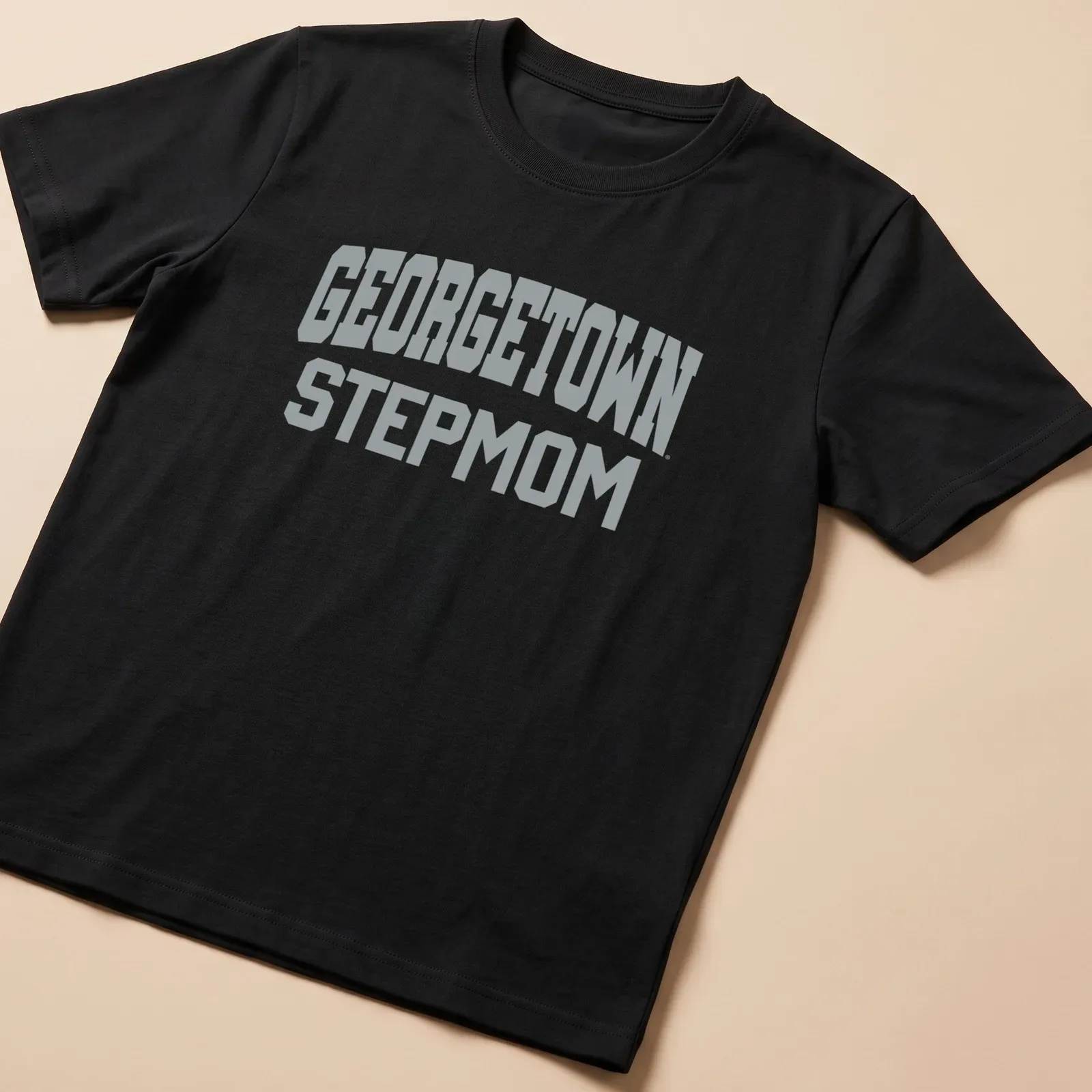 Gray t-shirt with bold collegiate print stating 'Georgetown Stepmom' — printed on a unisex t-shirt