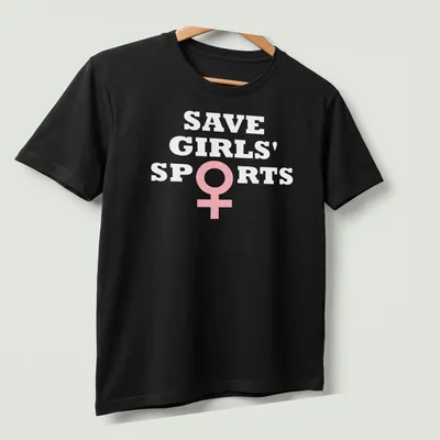 Bold typography t-shirt with the message Save Girls' Sports Biological Females in pink and white — printed on a unisex t-shirt (angled view)
