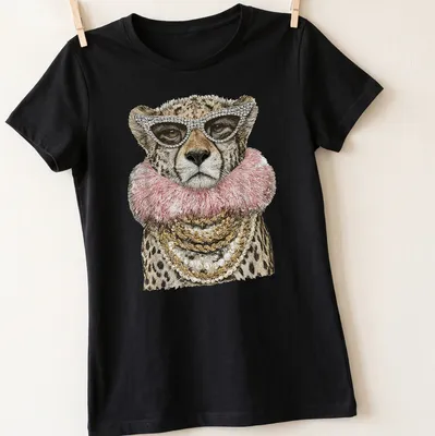Realistic cheetah wearing sunglasses in gold, pink, and black tones — printed on a women's shirt