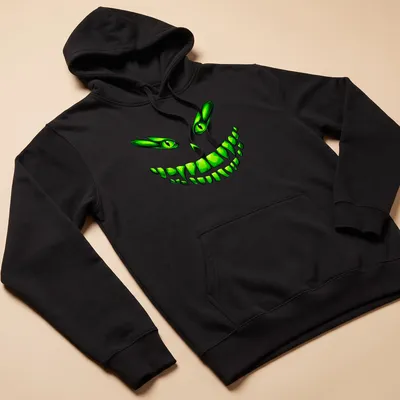 Cartoon design of a glowing green monster face with a mischievous grin — printed on a unisex hoodie