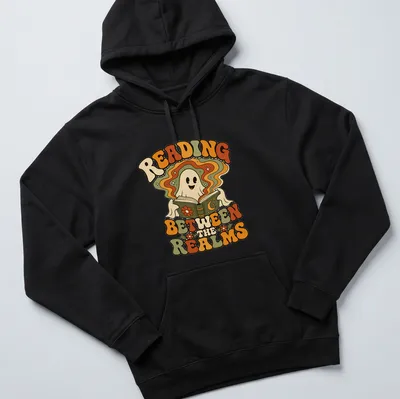 Retro style shirt with a playful ghost and the text 'Reading Between The Realms' in vibrant colors. — printed on a unisex hoodie