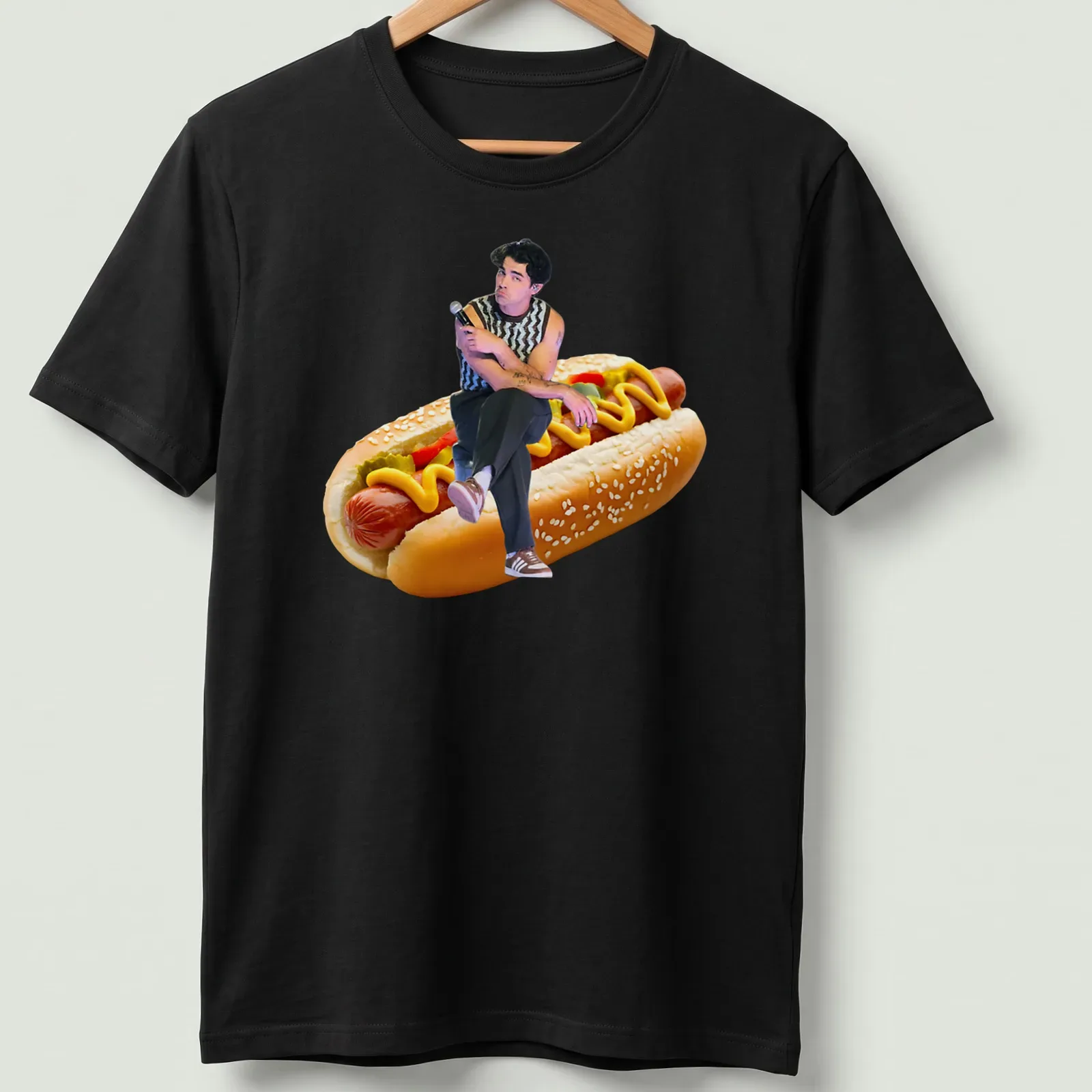 Funny illustration of Joe Jonas sitting on a hot dog with colorful toppings. — printed on a unisex t-shirt