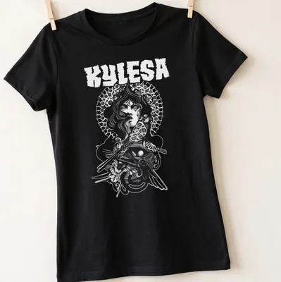 Illustrative design of a woman with floral halo and the text Kylesa Woman Of Wisdom — printed on a women's shirt