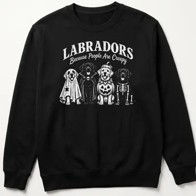 Funny cartoon t-shirt featuring Labradors in Halloween costumes and text — printed on a unisex sweatshirt