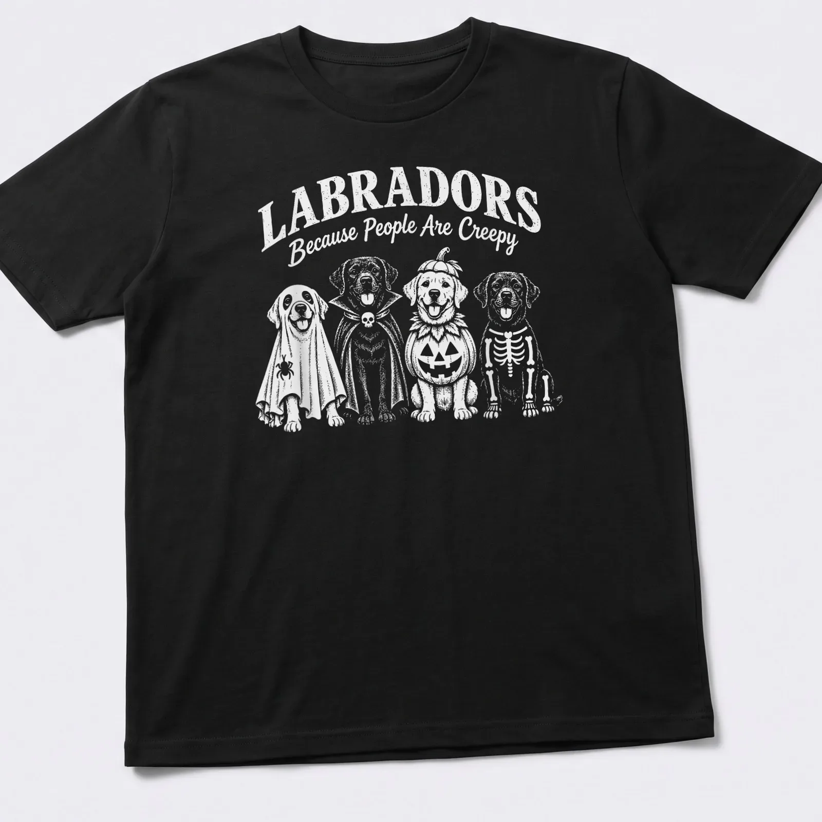 Funny cartoon t-shirt featuring Labradors in Halloween costumes and text — printed on a unisex t-shirt
