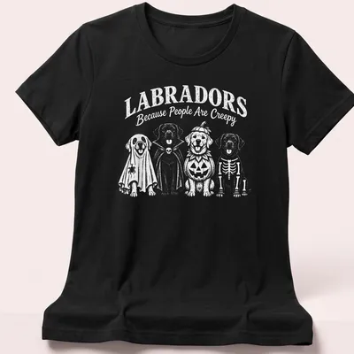 Funny cartoon t-shirt featuring Labradors in Halloween costumes and text — printed on a women's shirt